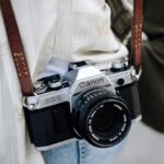 Close-up of vintage camera with leather strap, perfect for photography enthusiasts.