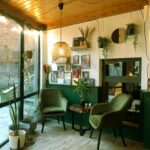 Inviting cafe interior with stylish decor and abundant natural light.